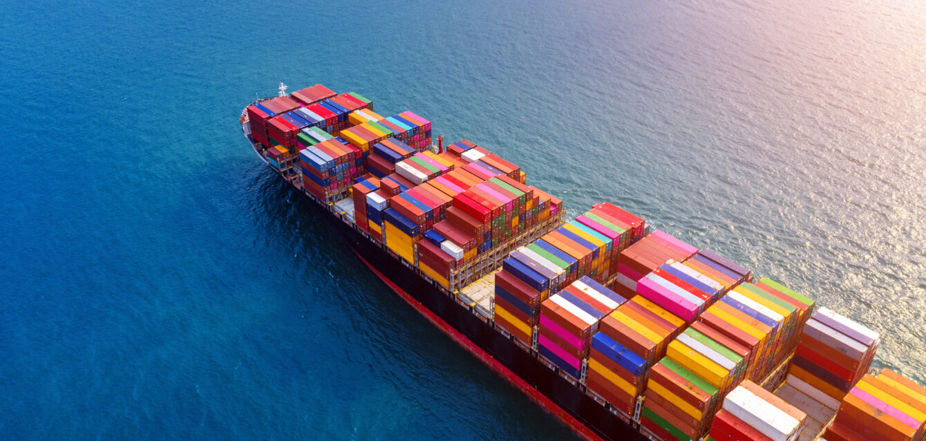 Aerial view of container cargo ship in sea.